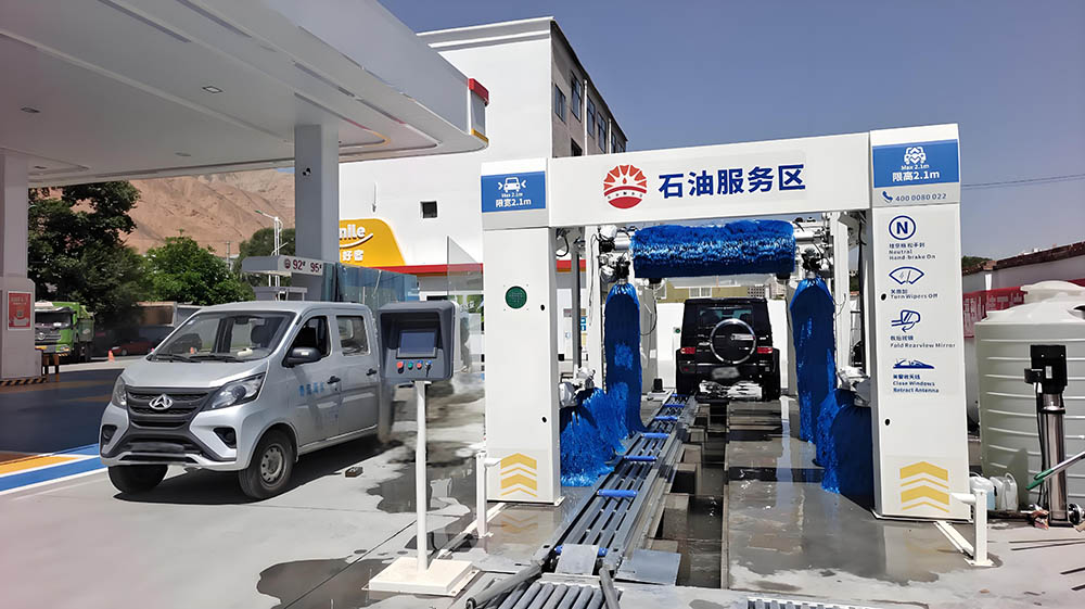 In-Bay Automatic vs. Conveyorized Tunnel Systems: Choosing the Right Car Wash for Your Business 2 A full-service tunnel car wash with attendants drying vehicles post-wash