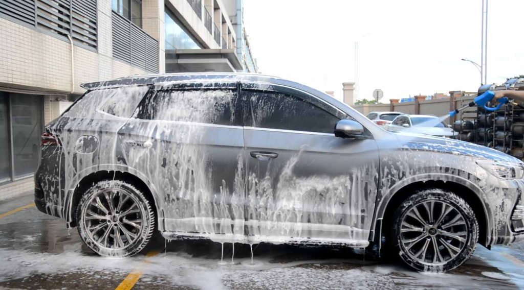 How Profitable Is a Self-Serve Car Wash? 1 self-serve car wash bay with customers using spray